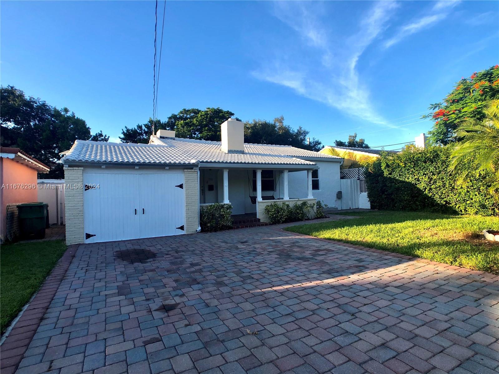 a front view of house with yard and trees