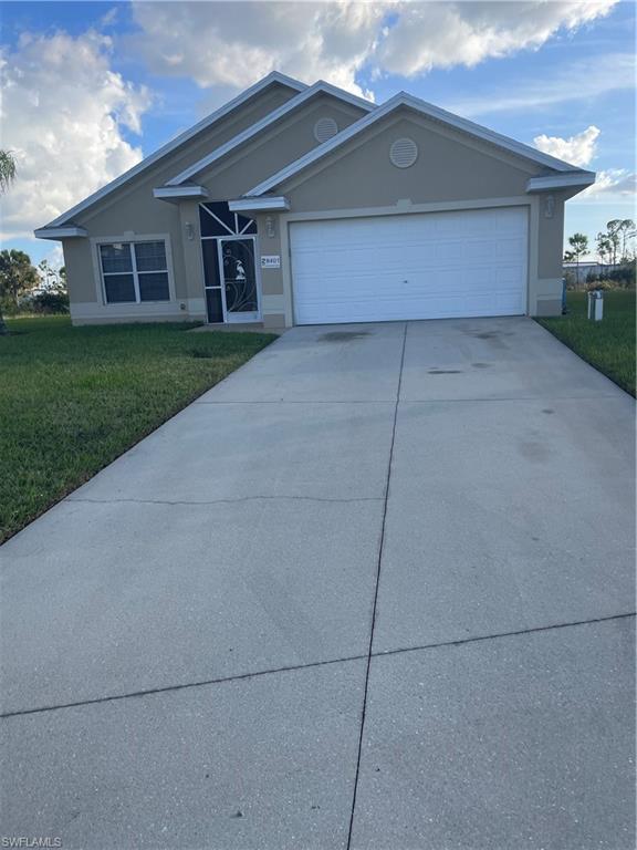 a view of a house with a yard and garage