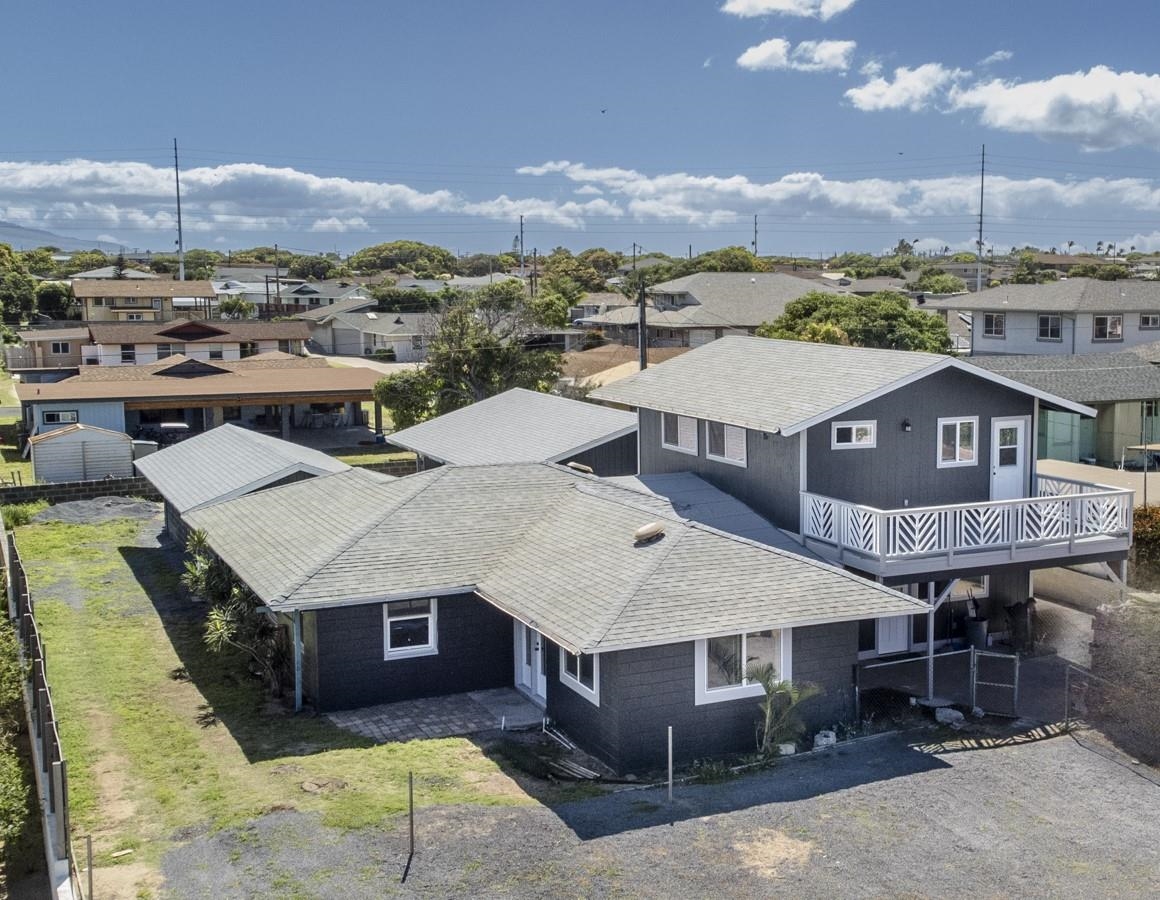 a aerial view of a house with a yard table and chairs