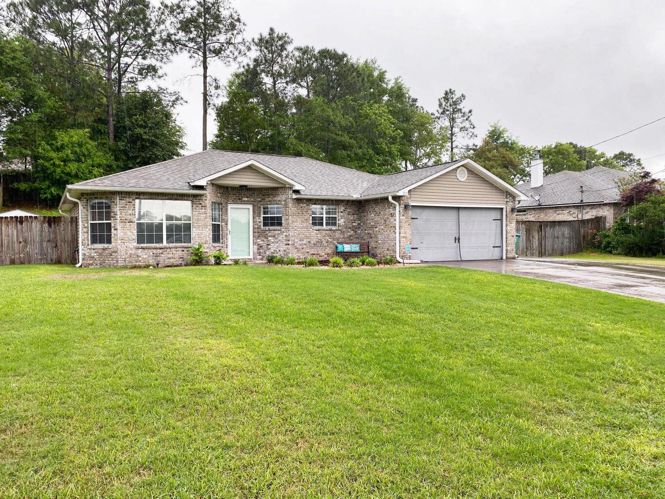 a view of a house with a yard and sitting area