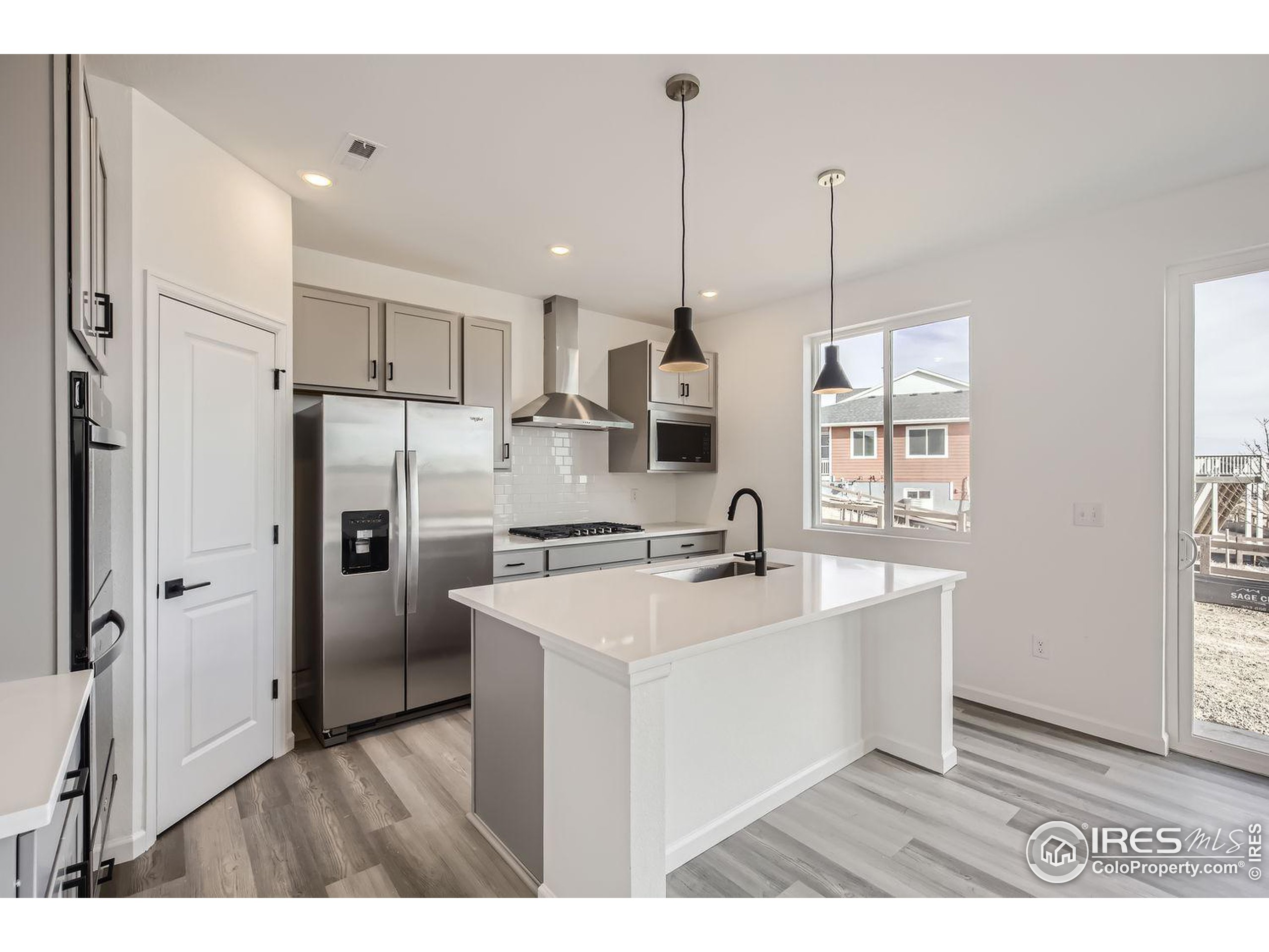 a kitchen with kitchen island a sink stove and refrigerator