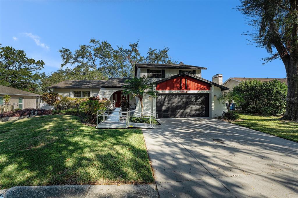 a view of a house with a yard fire pit and outdoor seating