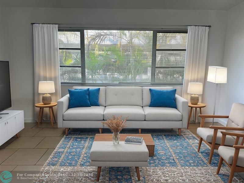 a living room with furniture and a large window