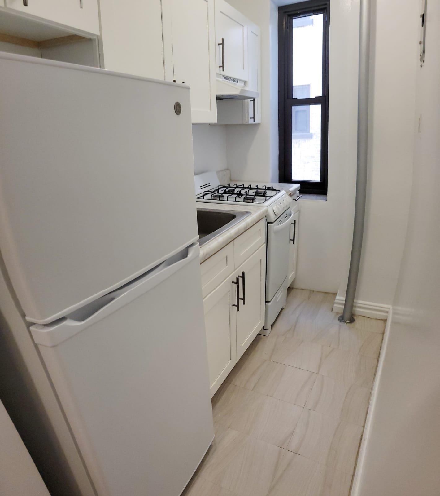 a kitchen with cabinets and white appliances