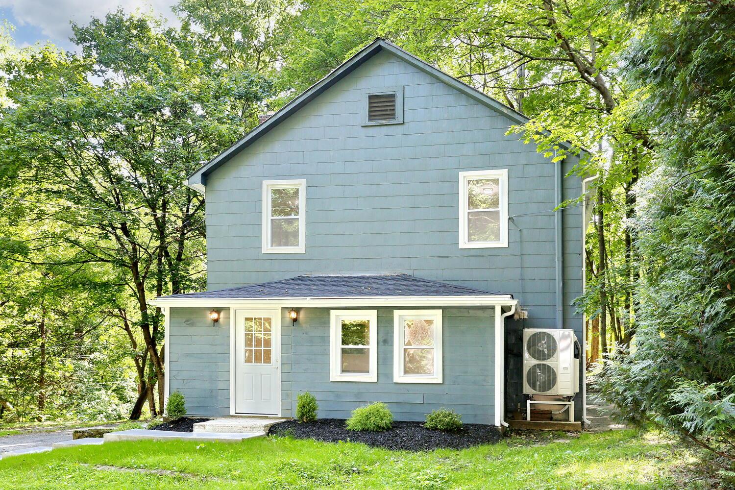 Rear view of house with a yard