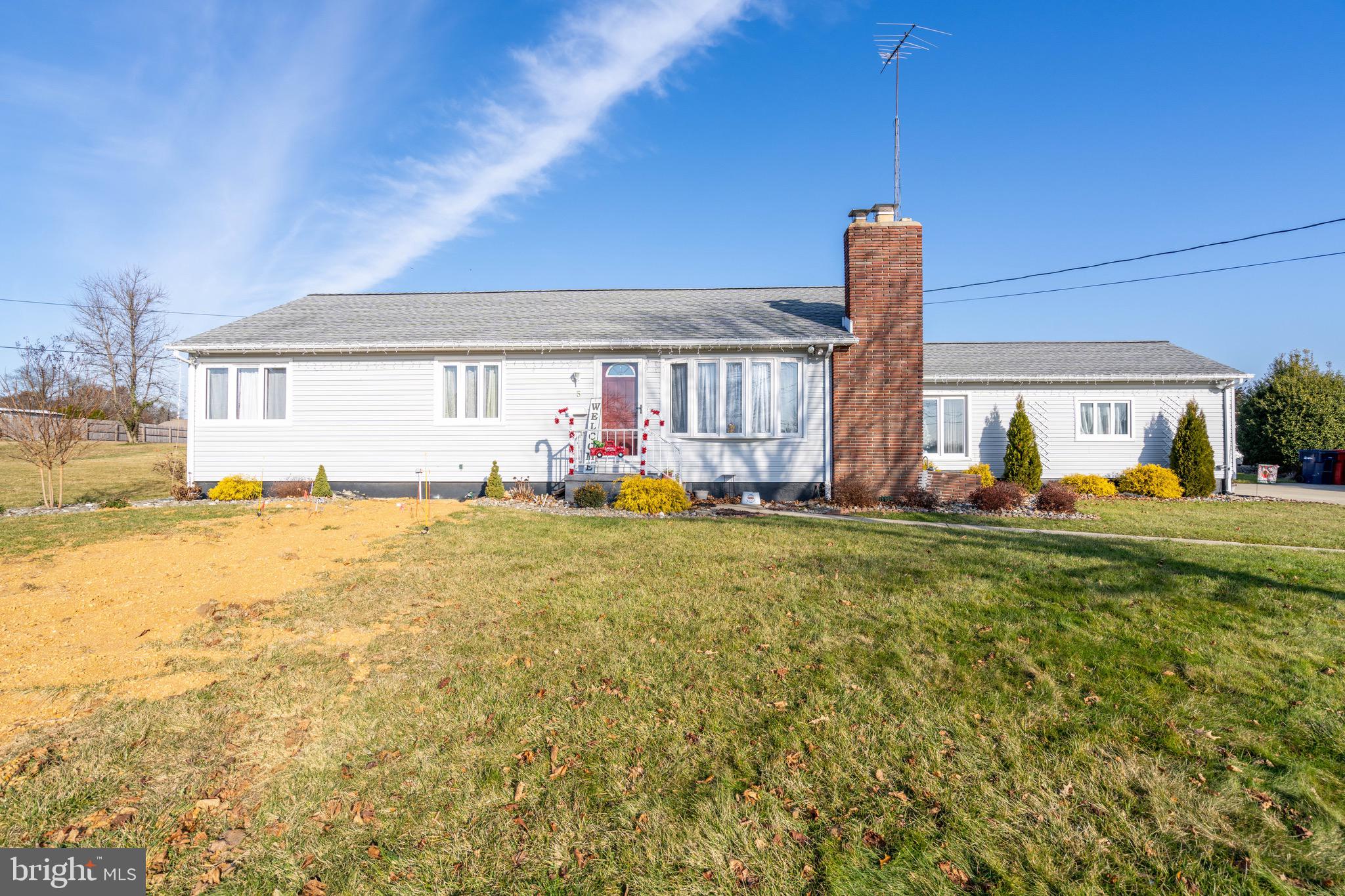 a front view of house with yard and seating area