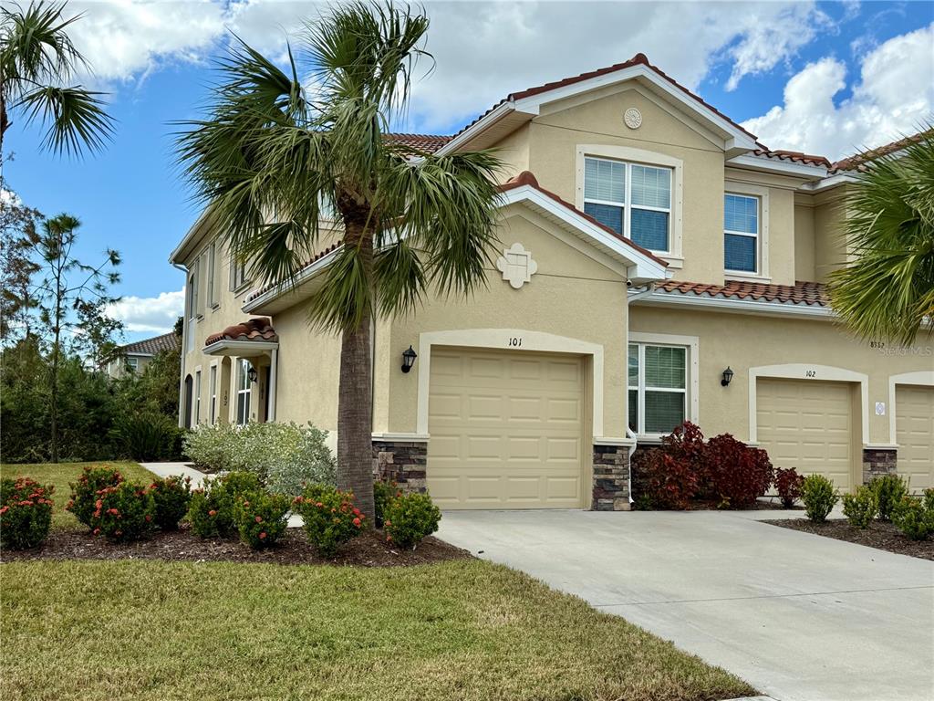 a front view of a house with a garden