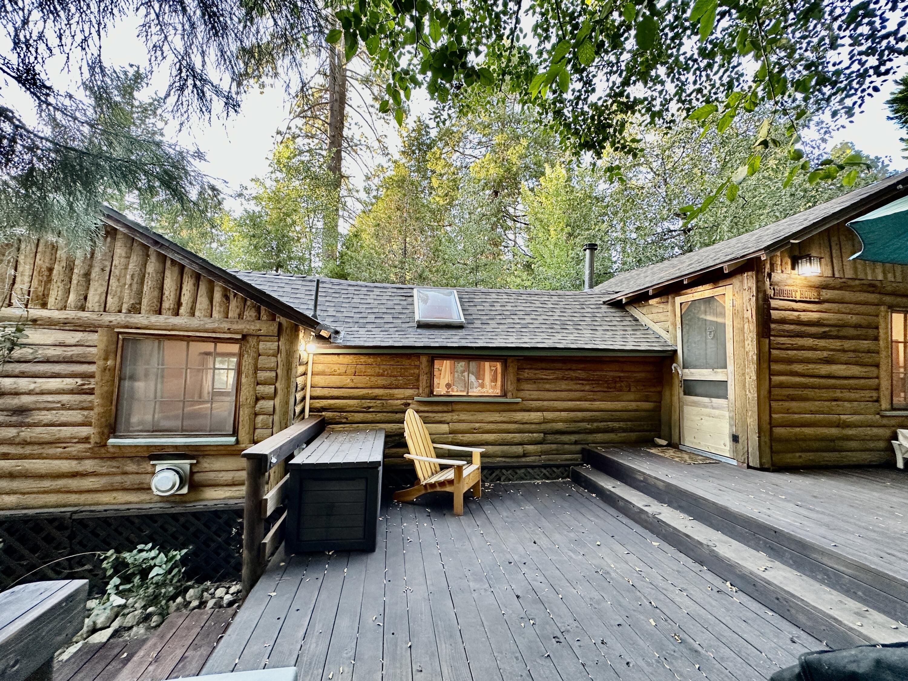 a backyard of a house with wooden floor a barbeque oven and outdoor seating