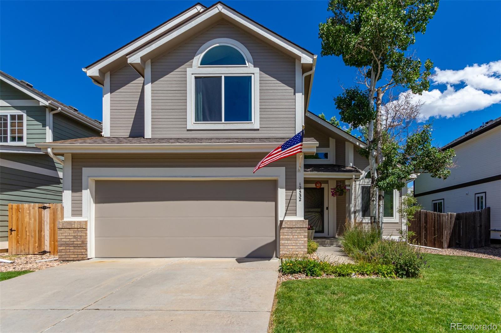 a front view of a house with a yard and garage