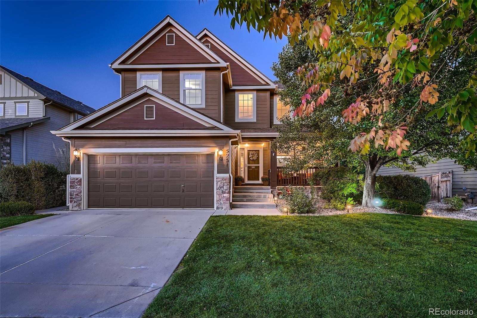 a front view of a house with a yard and garage