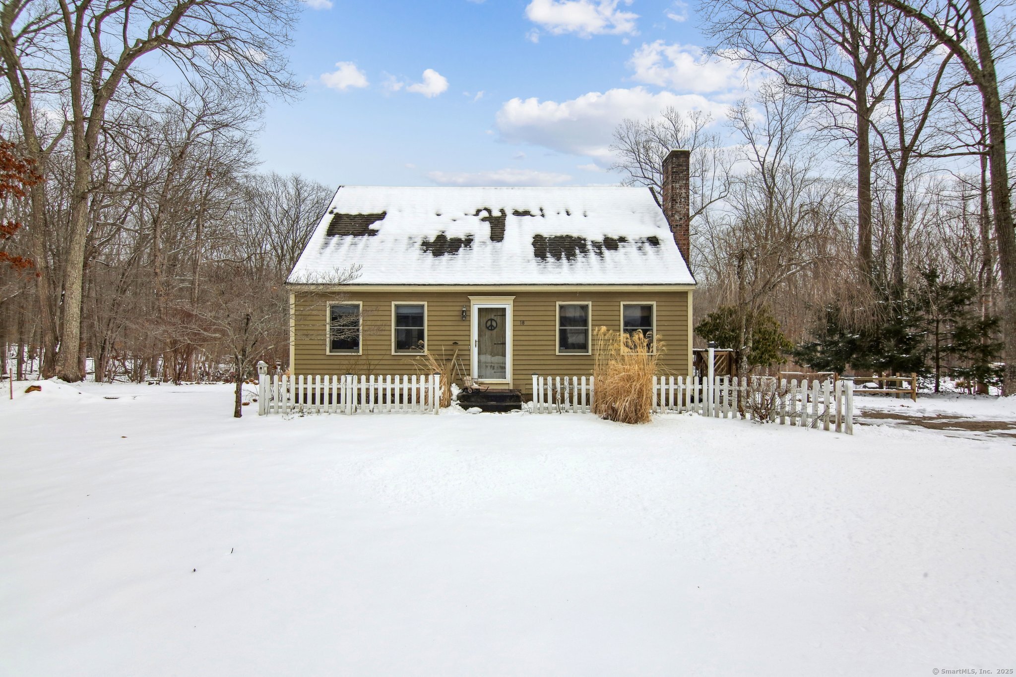 a view of a house with a yard covered in snow