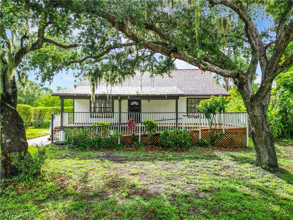 a view of house with a backyard