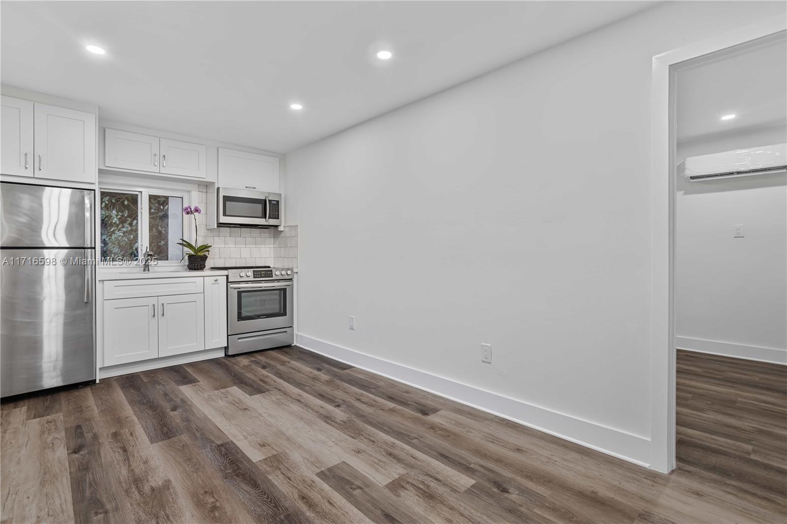 a view of kitchen with wooden floor