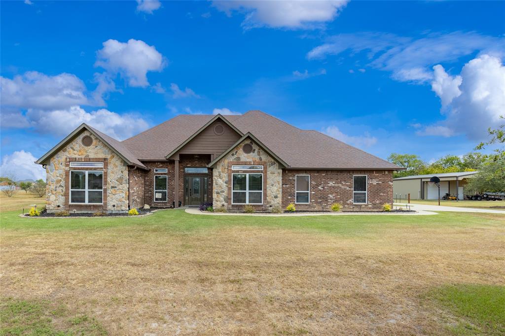 a front view of a house with a yard