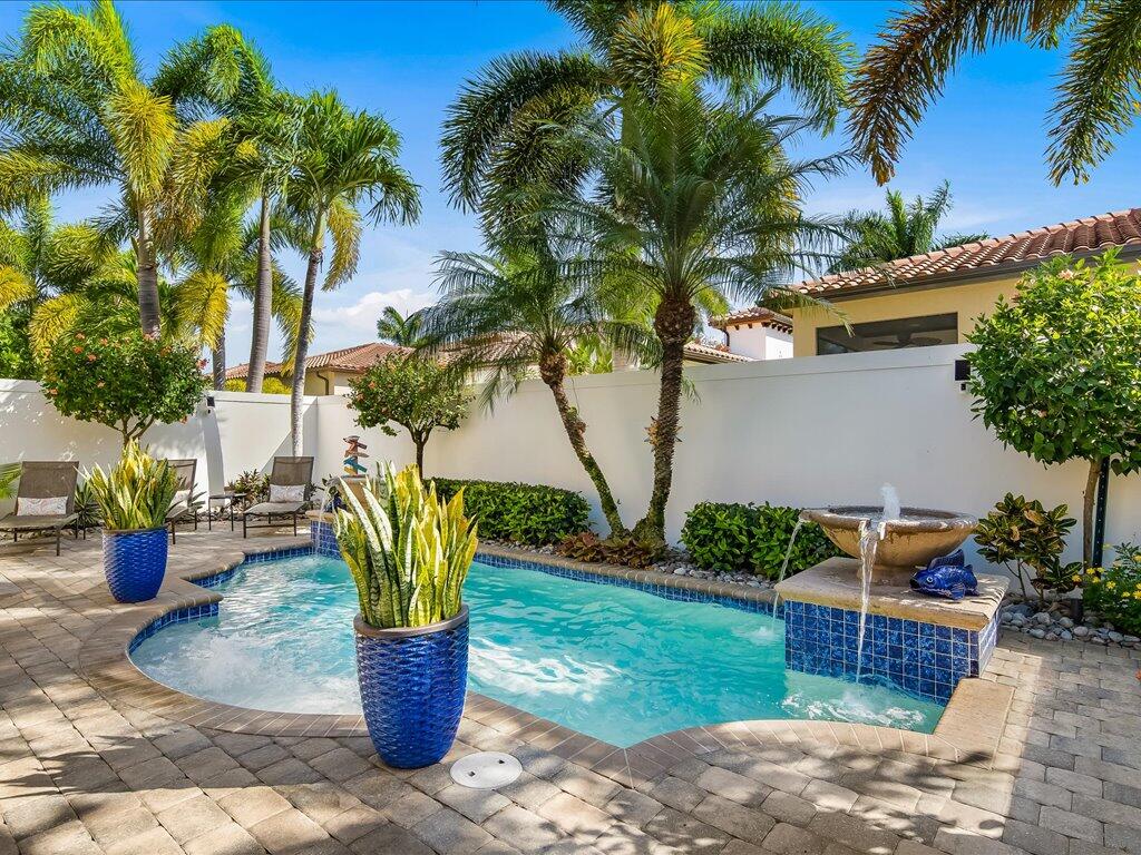 a view of a backyard with swimming pool