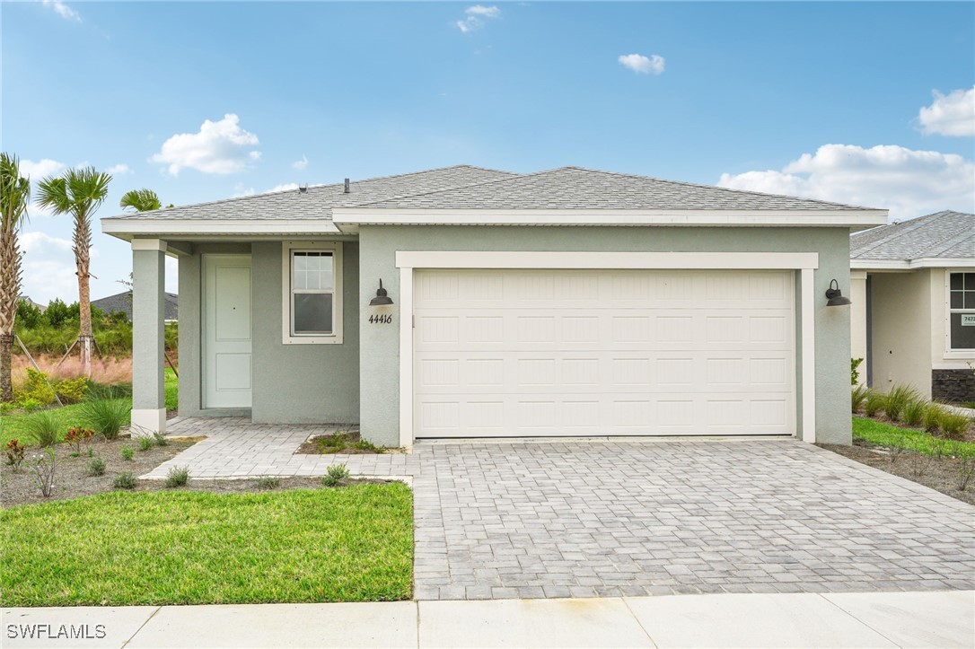 a front view of a house with a yard and garage