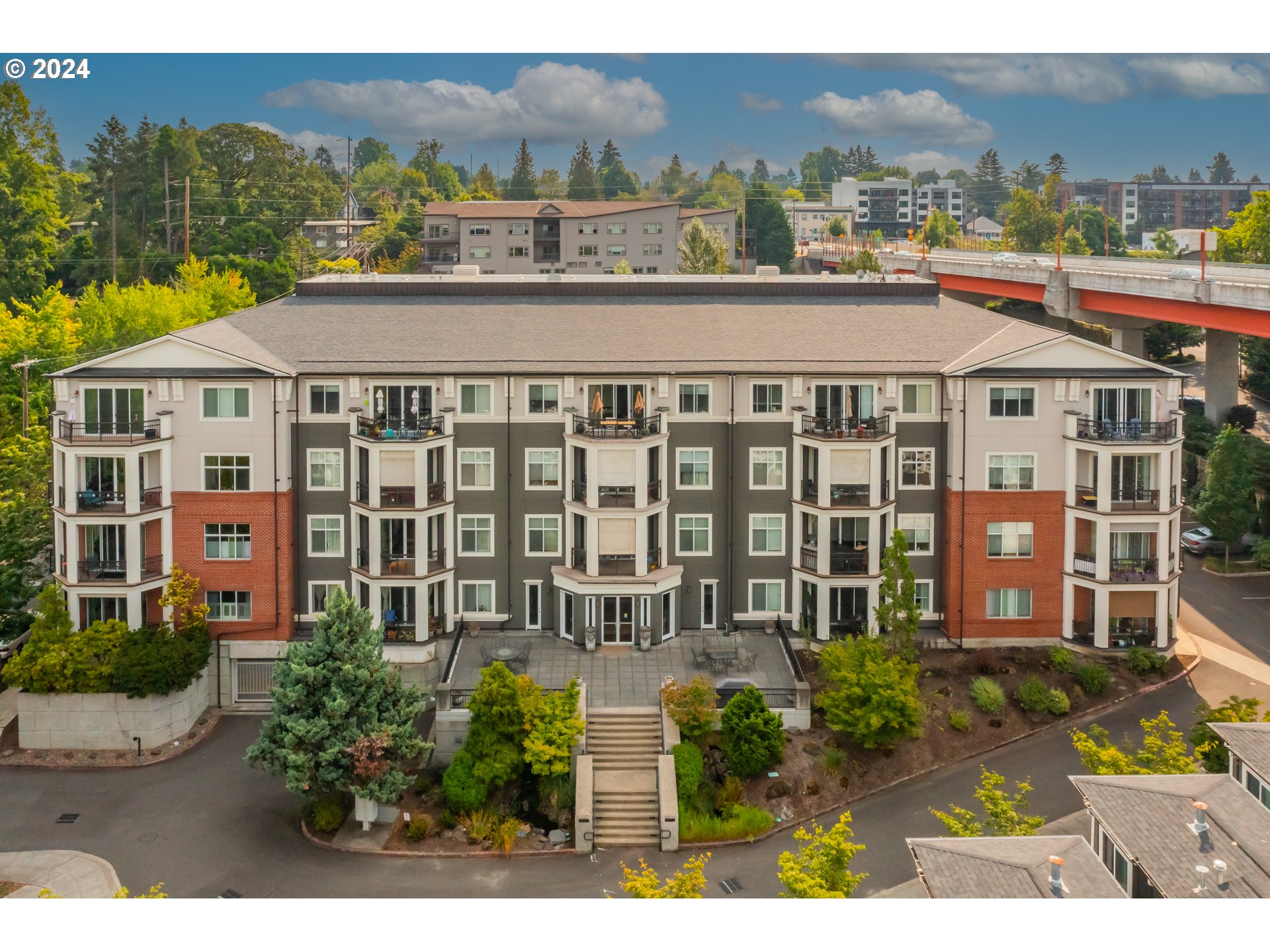 a front view of a residential apartment building with a yard