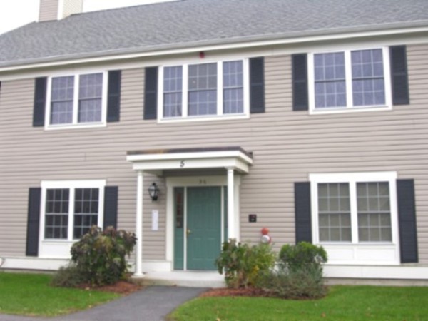 a front view of a house with garden and porch