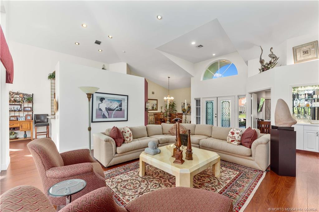 a living room with furniture and wooden floor