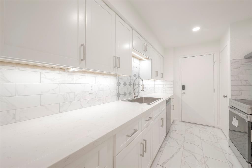 a kitchen with white cabinets