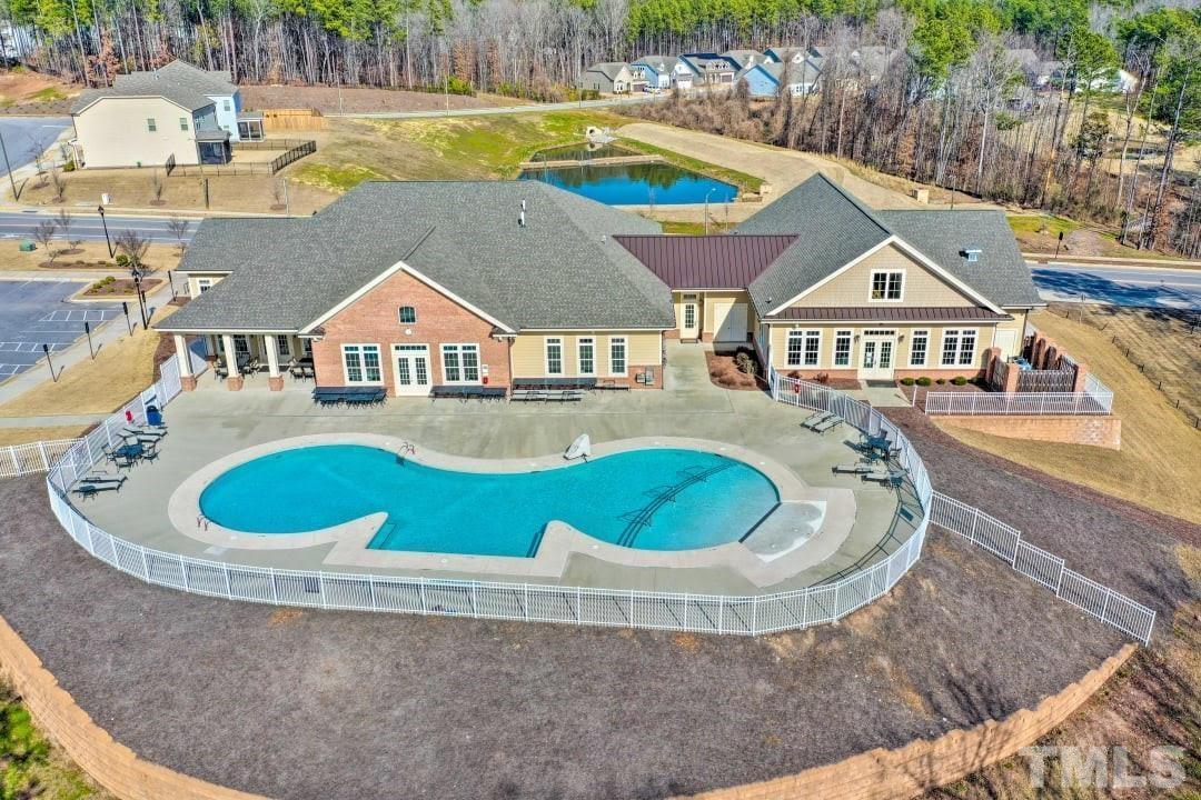 an aerial view of a house with outdoor space and swimming pool