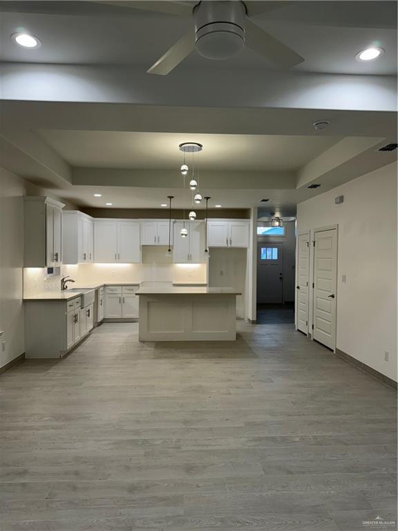 a large white kitchen with a white countertops