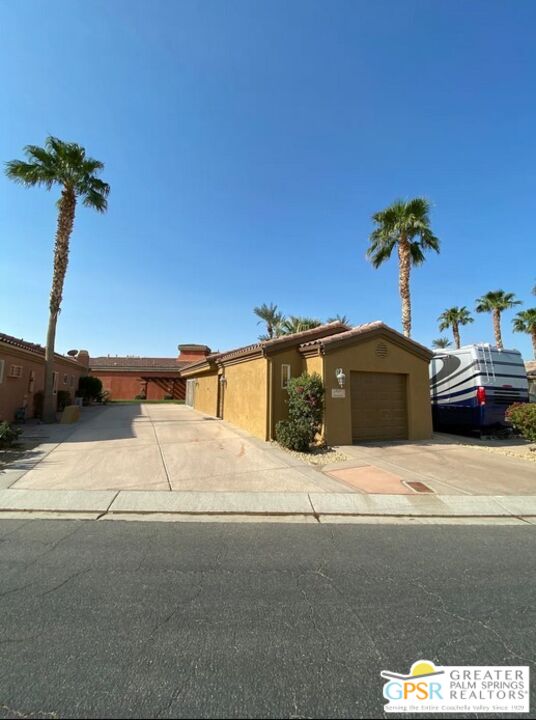 a front view of a house with a road