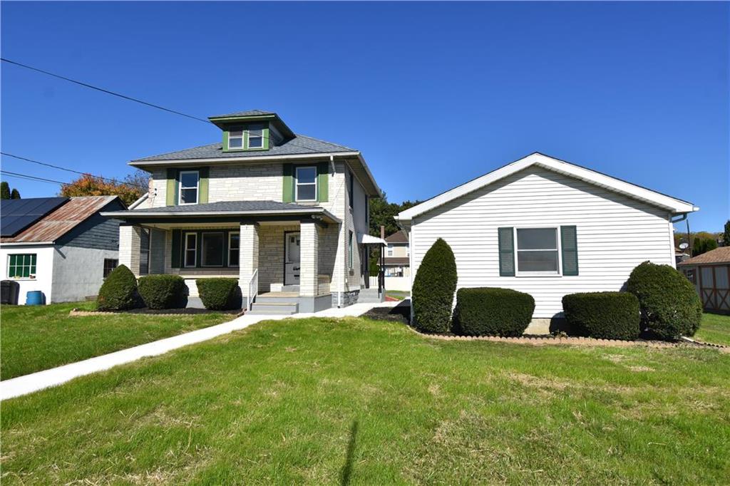 a front view of a house with a garden