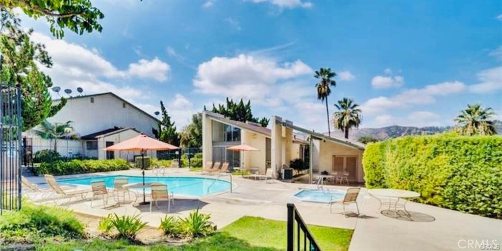 a view of a house with swimming pool and a yard