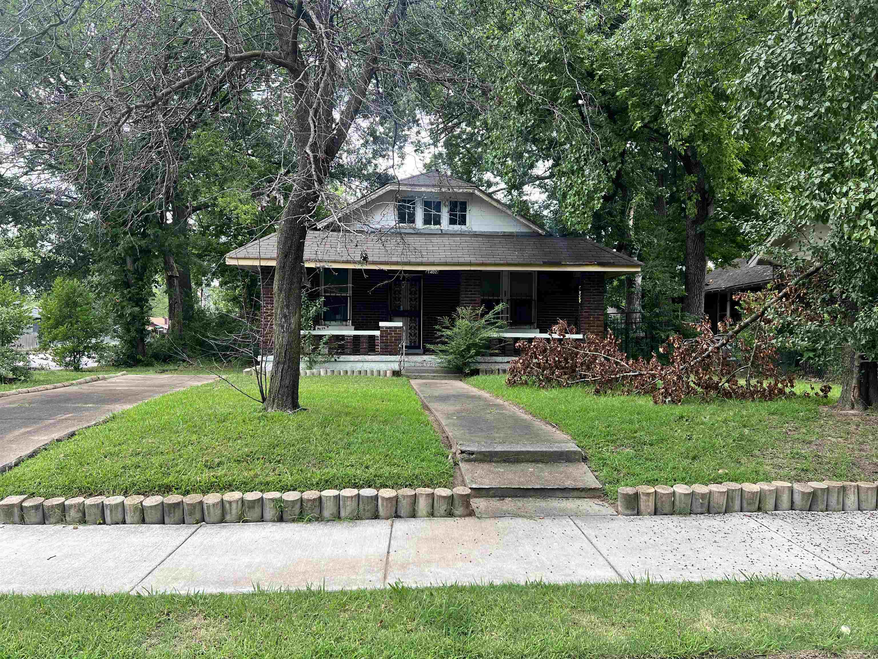 View of front of house with a porch and a front lawn