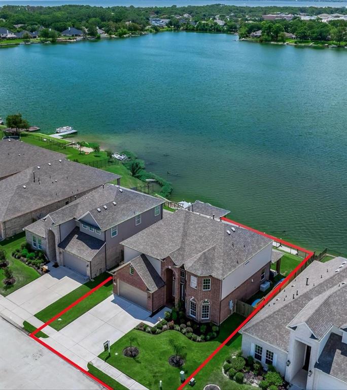 an aerial view of a house with a lake view