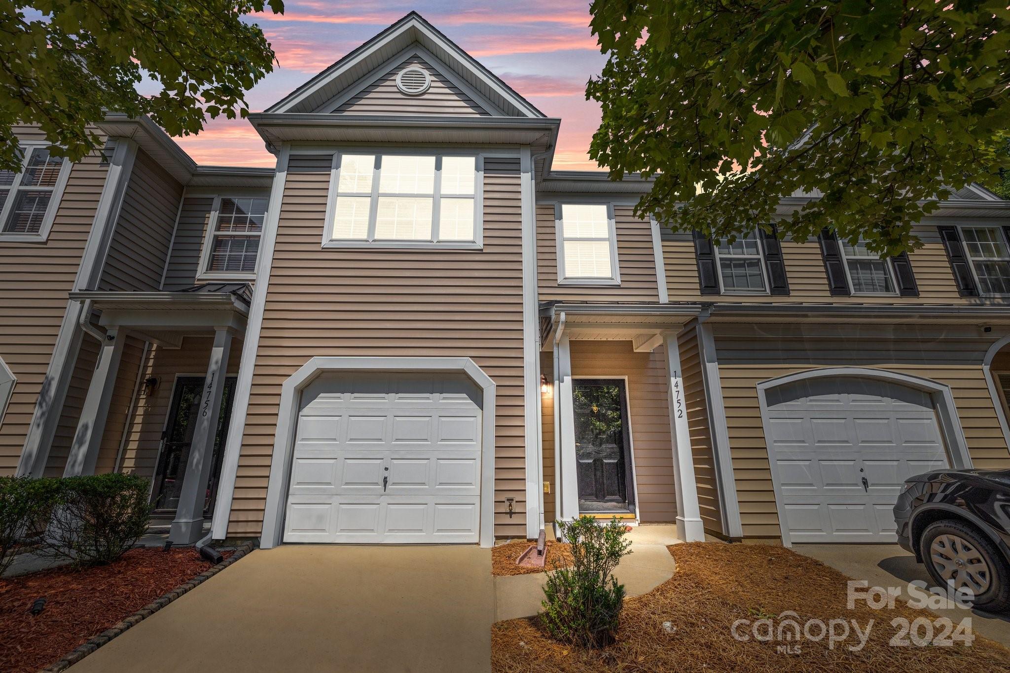 a front view of a house with a garage