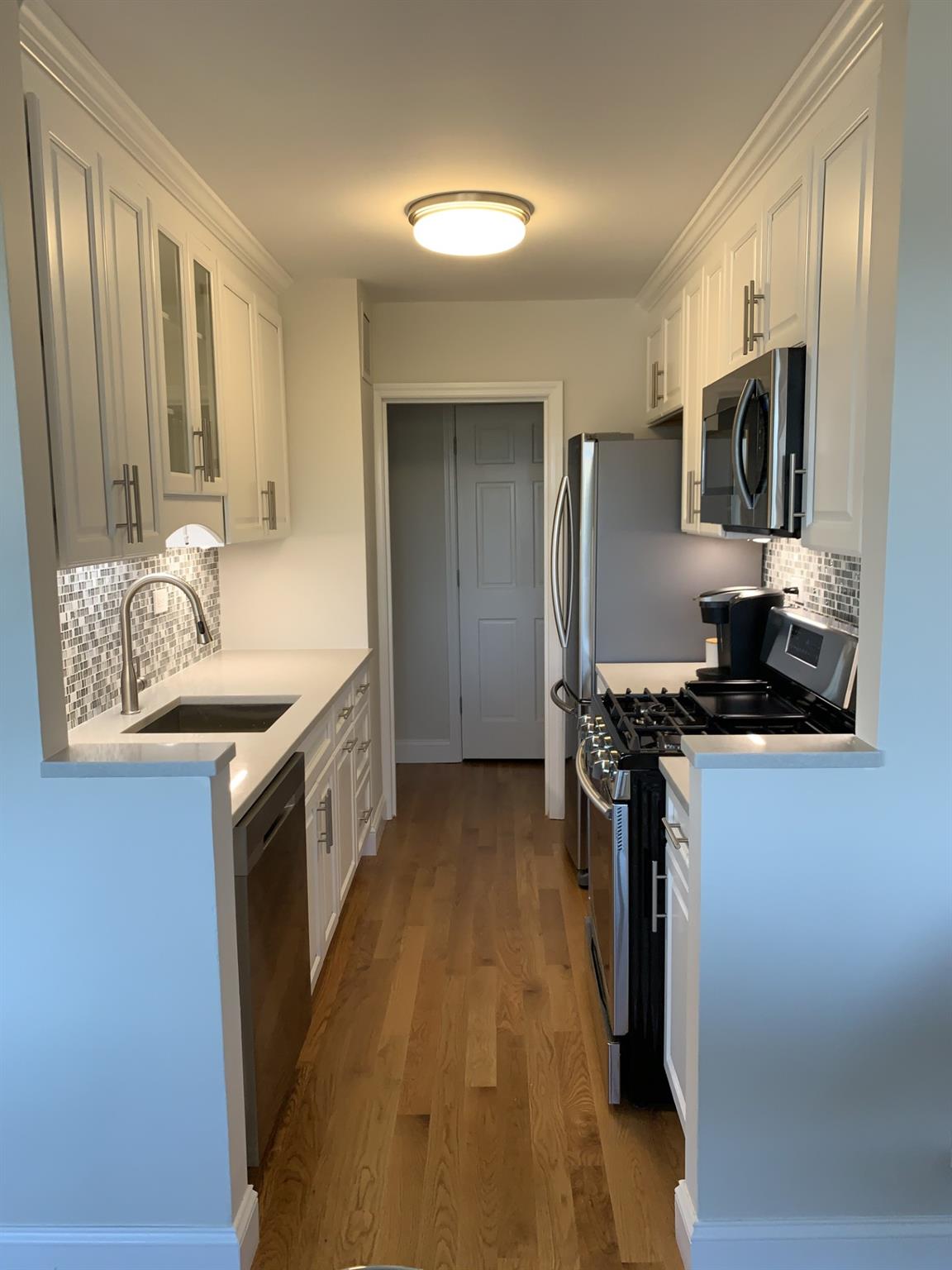 a kitchen with stainless steel appliances granite countertop a sink stove and refrigerator