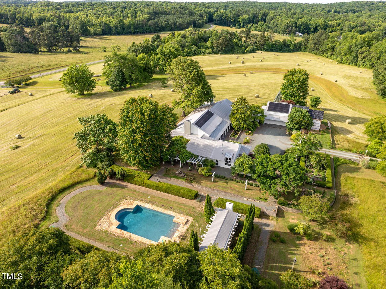 a view of a swimming pool with a patio and garden