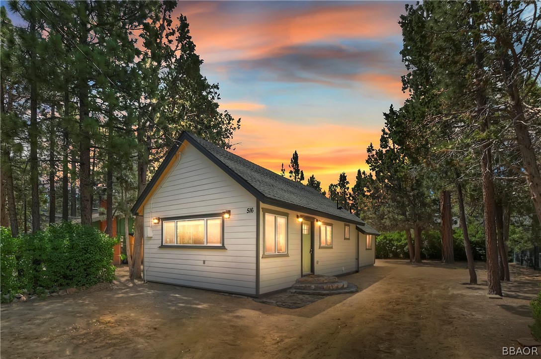 a view of a house with a yard and tree s