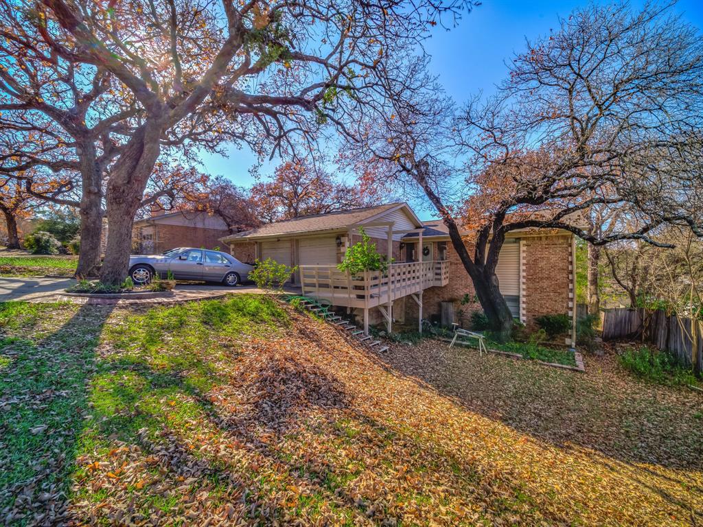 a view of house with backyard and trees