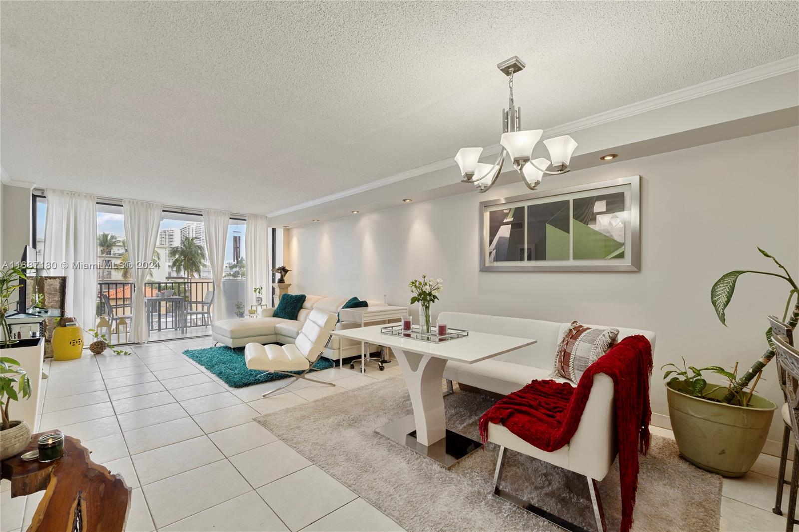 a living room with furniture a chandelier and a dining table