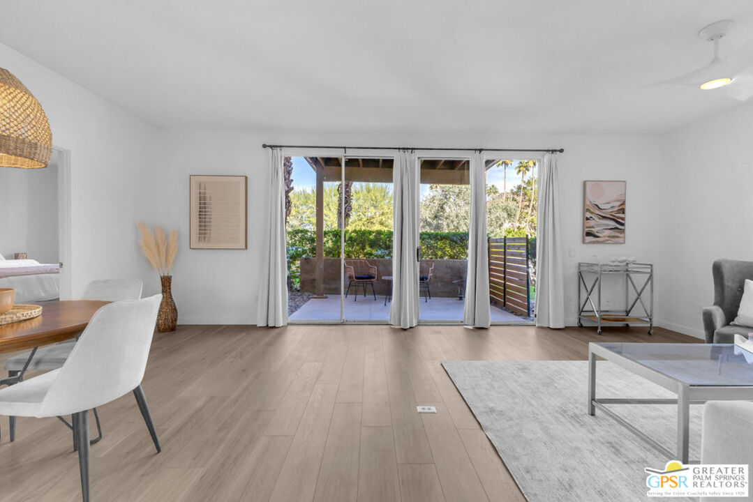 a living room with furniture and large windows