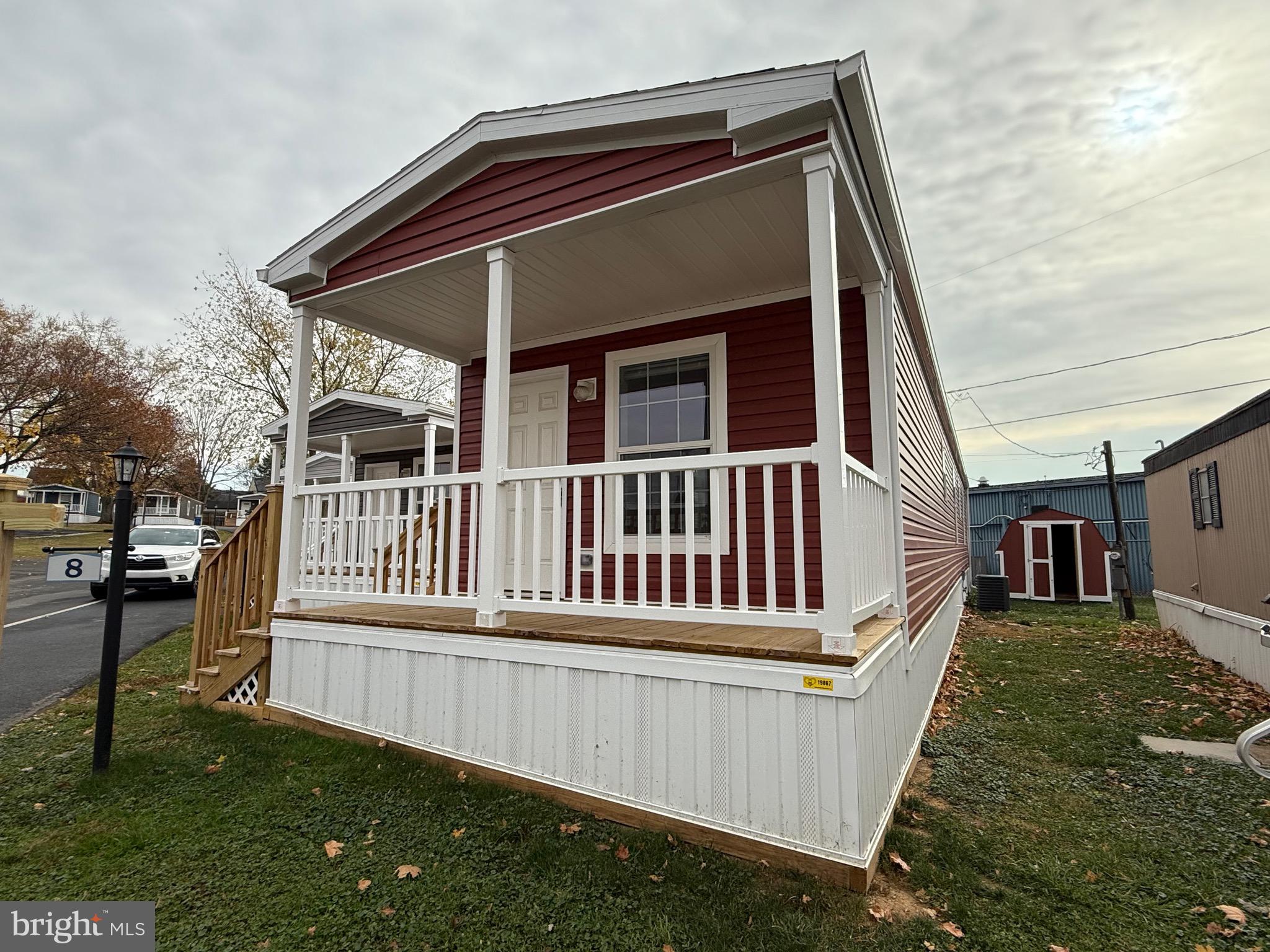 a view of a house with a yard and deck