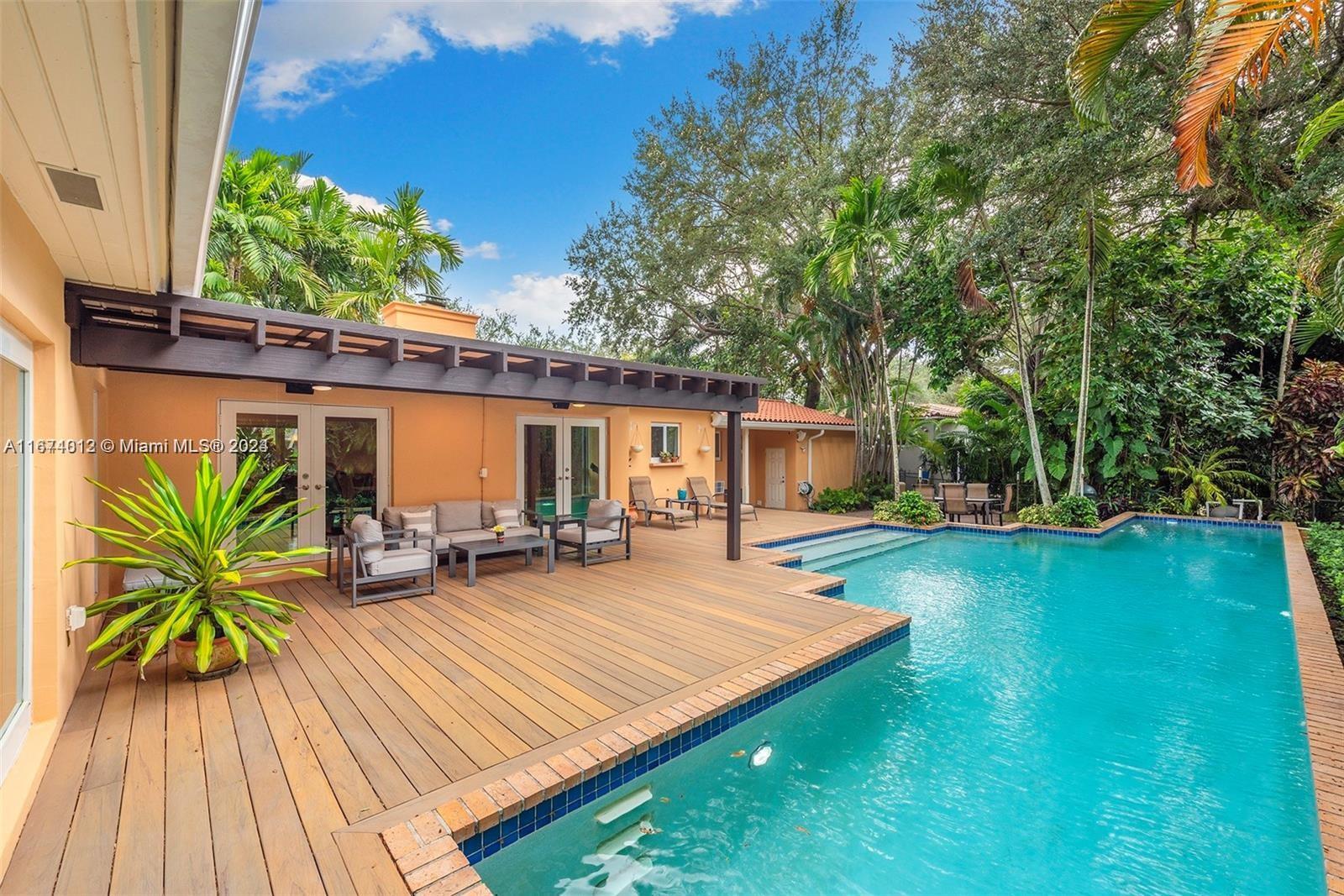 a view of a house with pool porch and sitting area