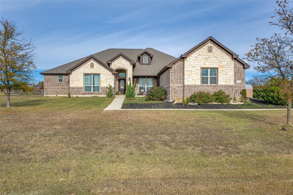 a front view of house with yard and green space