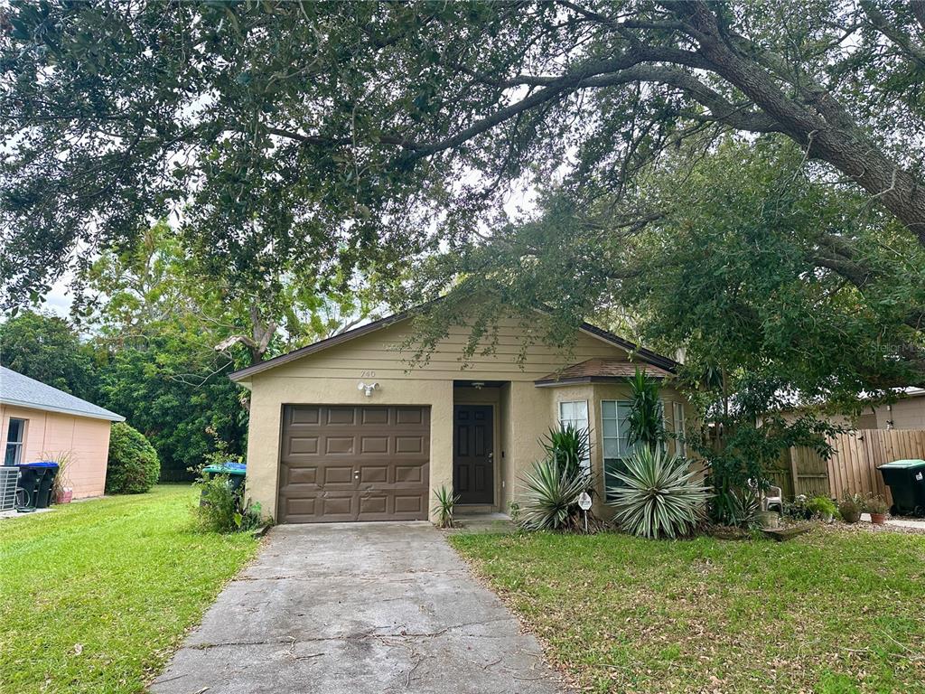 a front view of a house with a garden and yard