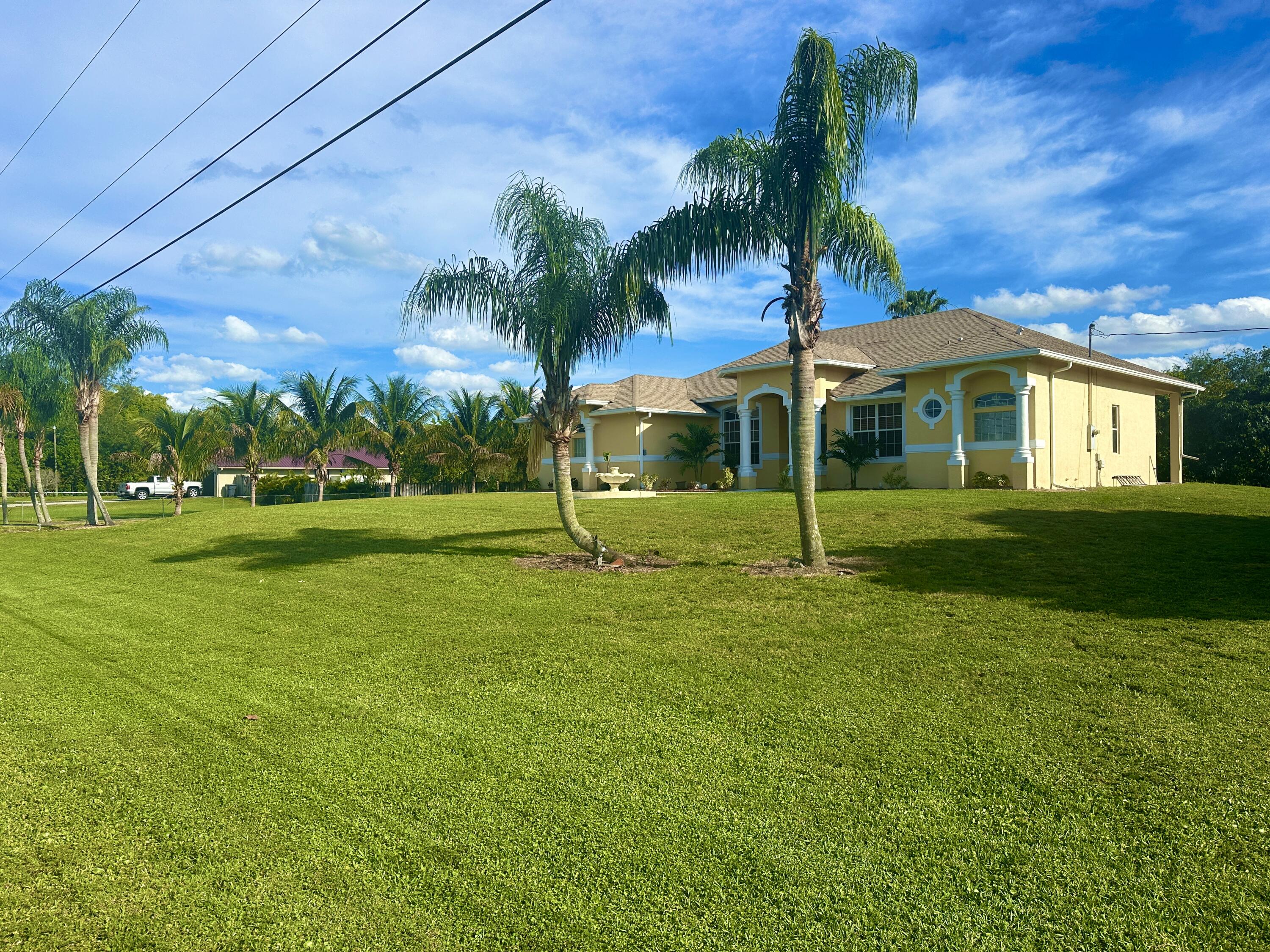 a view of a house with a backyard