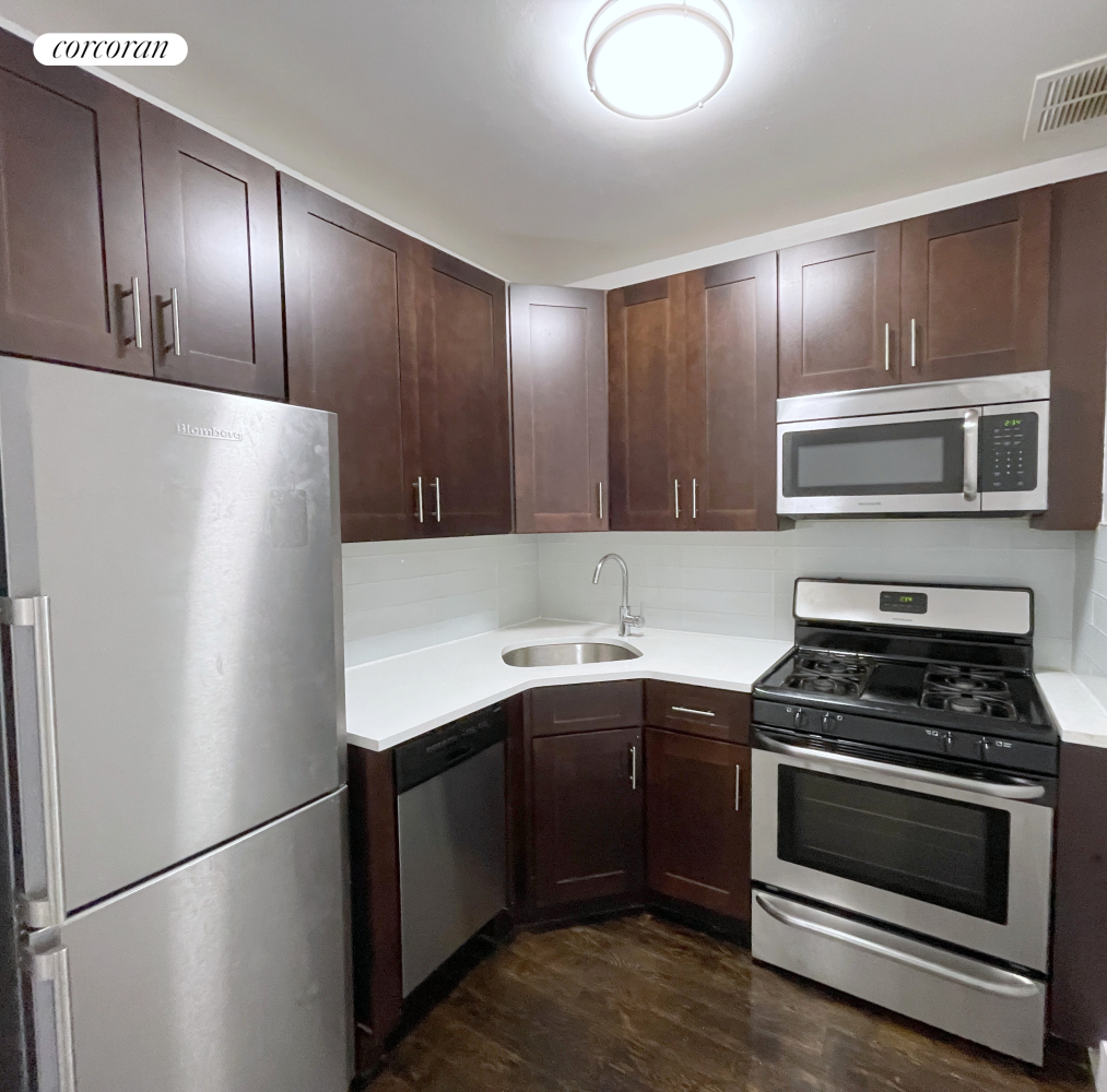 a kitchen with a refrigerator sink and cabinets