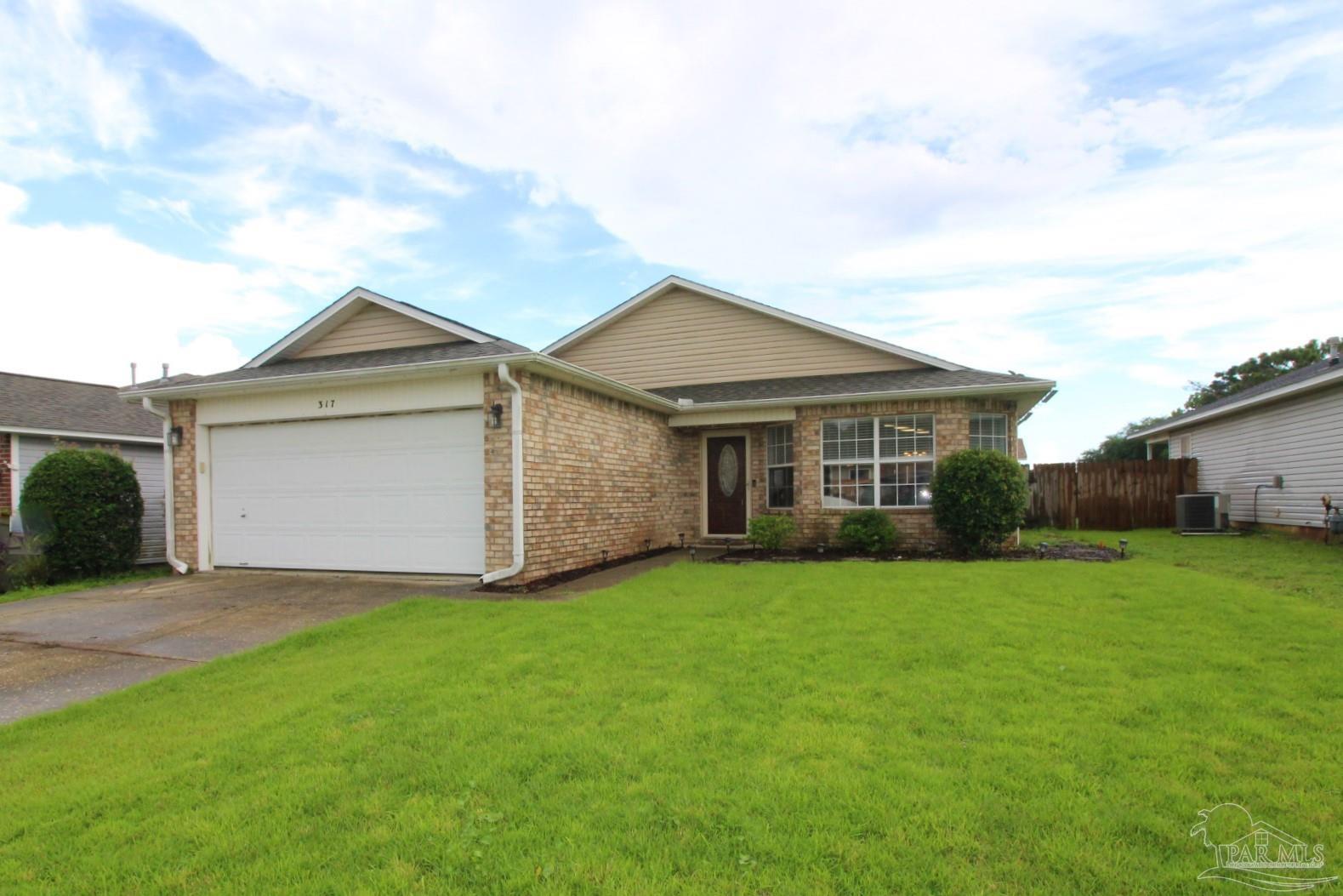 a view of a house with a yard and pathway