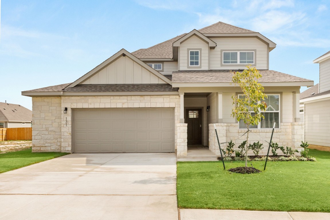 a front view of a house with a yard and garage