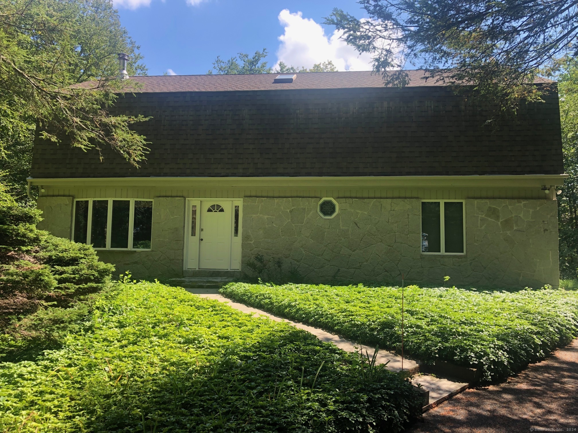 a view of a house with a large tree