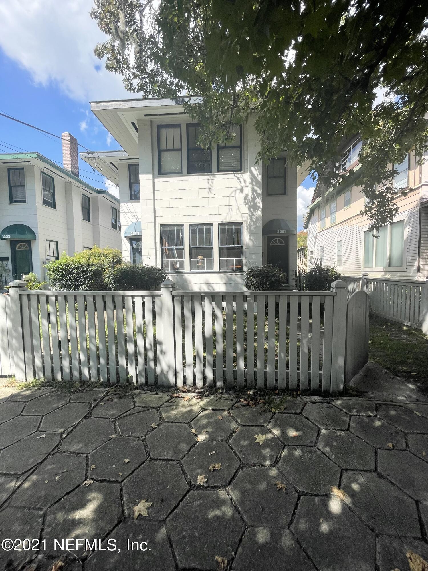 a front view of a house with a fence