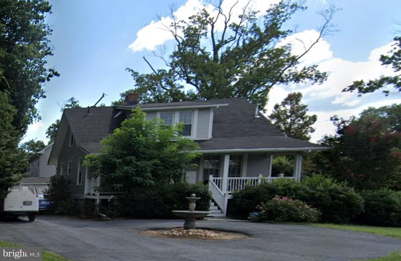 a front view of house with a garden