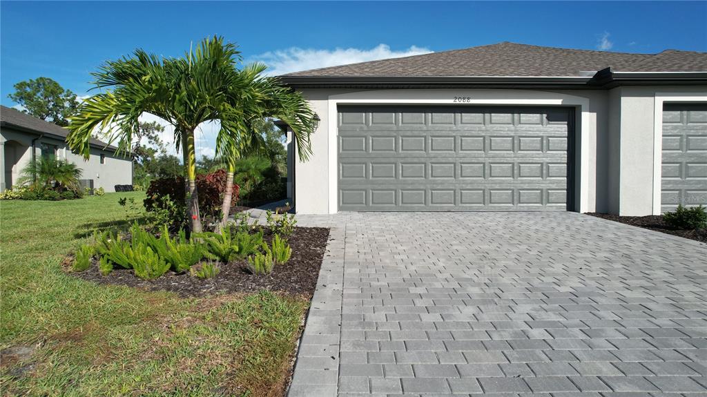 a front view of a house with a yard and garage